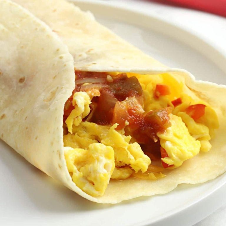 Breakfast burrito with scrambled eggs and salsa